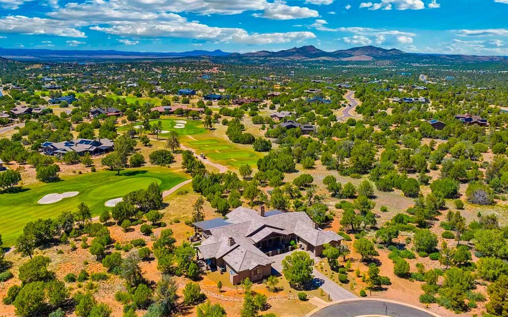 Bright daytime aerial view of Kokopelli custom home and golf course in Talking Rock Ranch