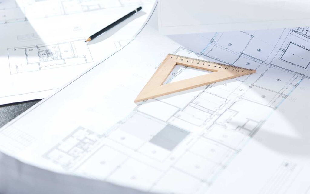 Residential building plans for a Prescott custom home laid out on a table during design and pre-construction