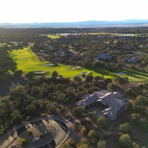 Aerial view of a Prescott custom home in Talking Rock Ranch backing to the golf course at sunset