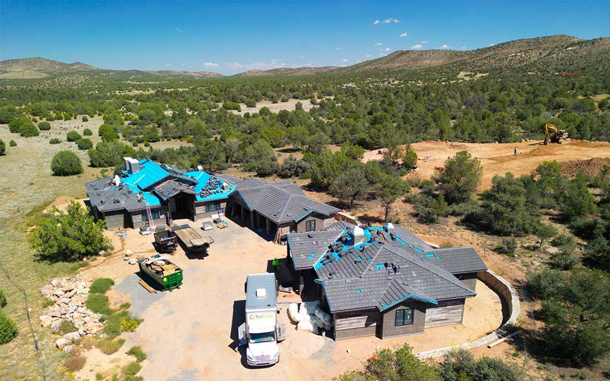 Aerial view of a Talking Rock Ranch custom home under construction during the roofing phase