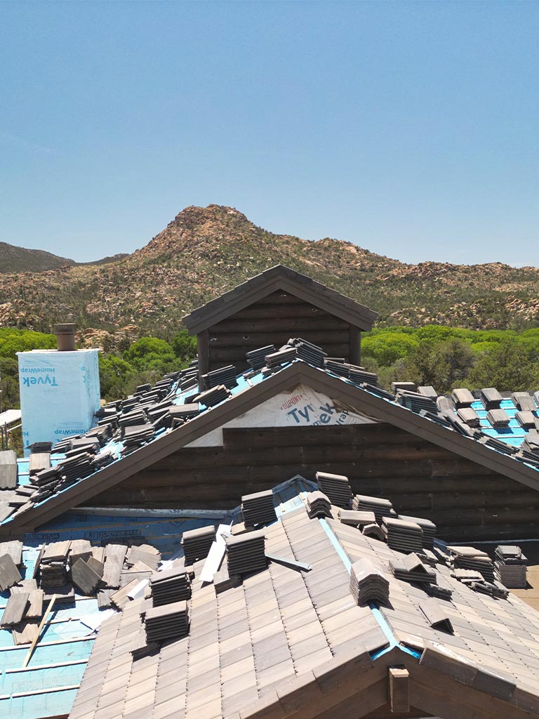 Artfully stepped roofline on a Talking Rock Ranch custom home under construction with Tyvek wrap and landscape-inspired forms