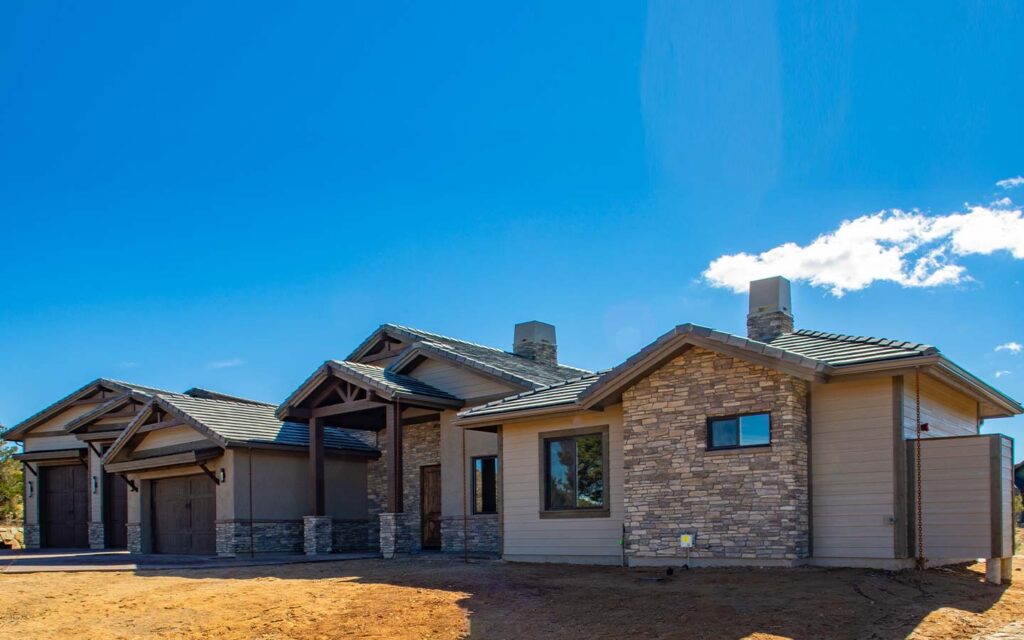 Dramatic roofline and deep shaded patio on an HBC custom home in Talking Rock Ranch