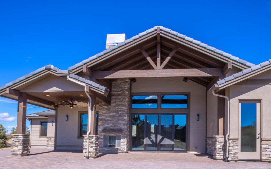 Talking Rock Ranch custom home back patio with double-wide sliding glass doors opening the great room to outdoor living