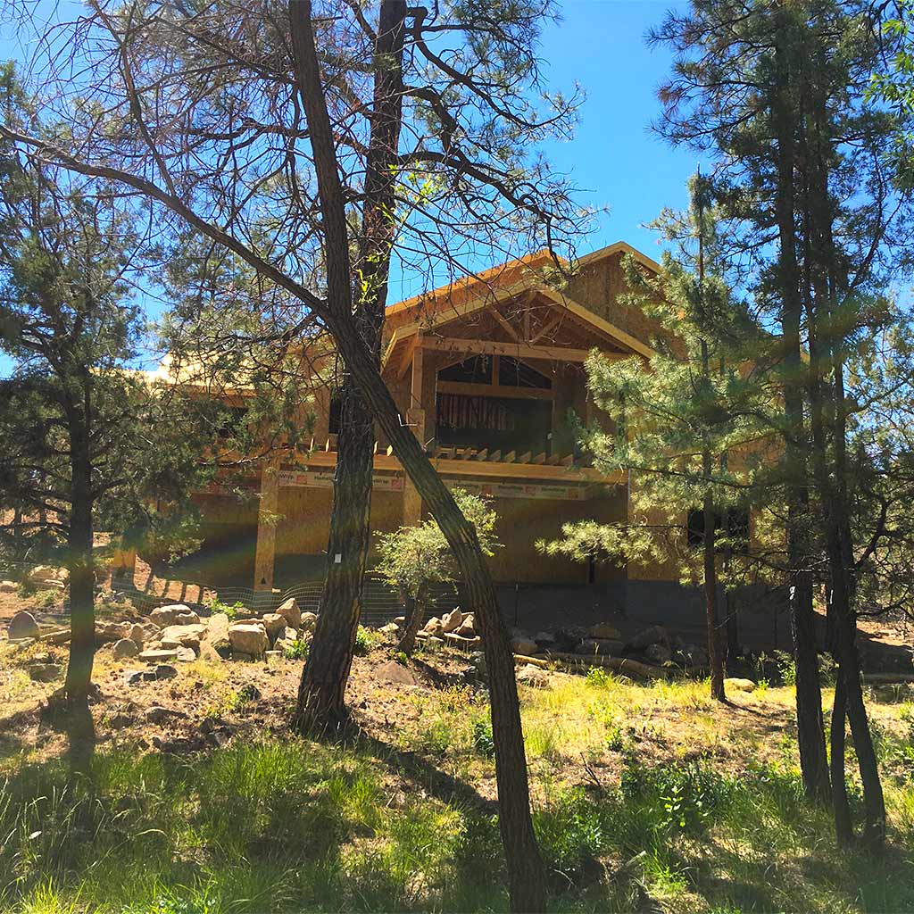 HBC Hassayampa custom home in early framing stage set among Prescott pines