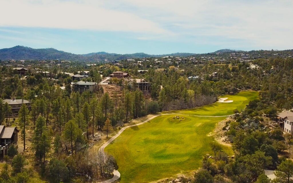 Aerial view of the Hassayampa golf course and surrounding pine forest in Prescott, Arizona.