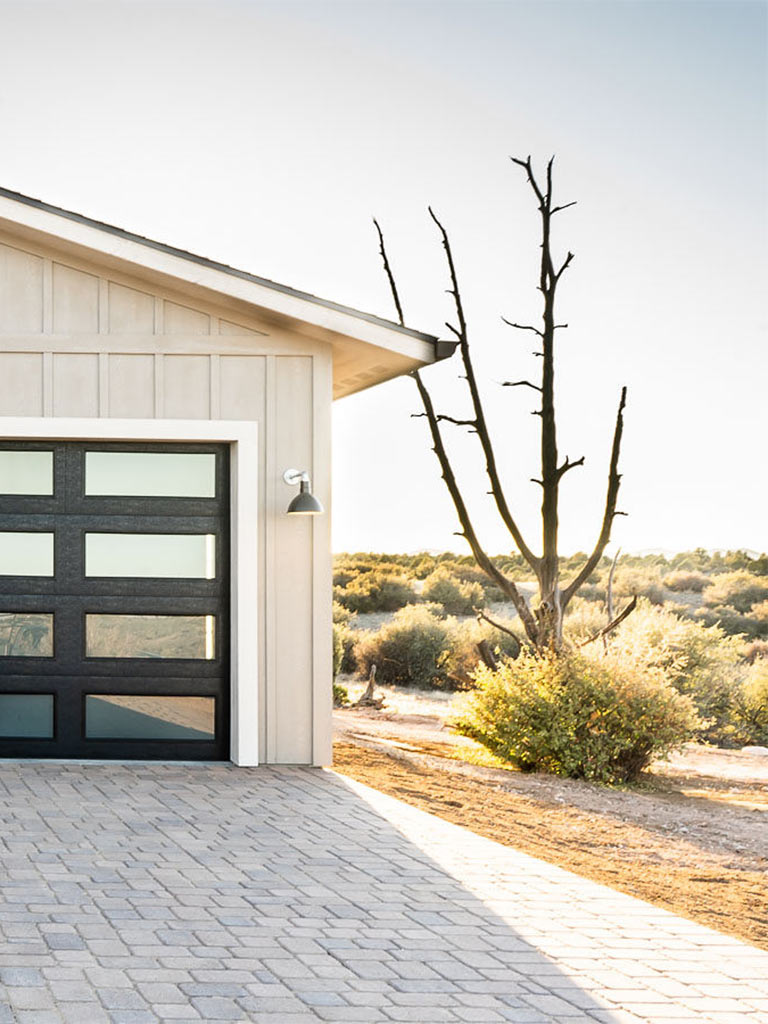 Las Vegas Ranch custom home garage exterior with modern door, paver drive, and high-desert landscape near Prescott, AZ