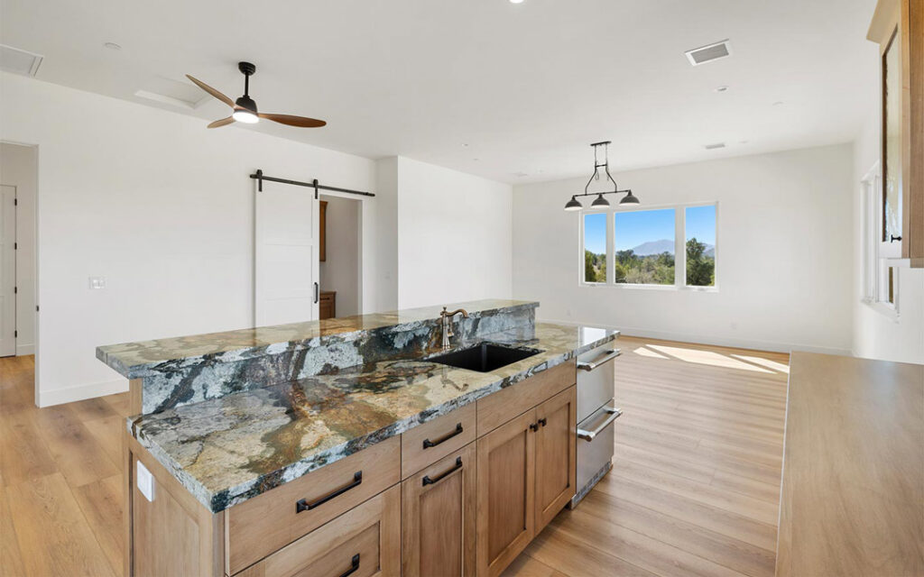 Open-concept Prescott custom home kitchen and living space with natural light and mountain views
