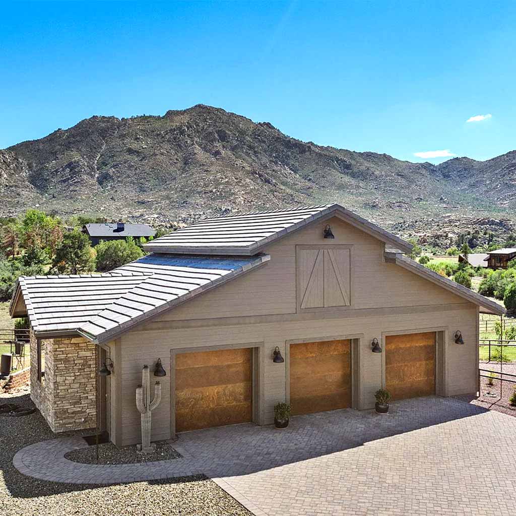 Barn-style garage at an HBC custom home in American Ranch with Granite Mountain in the background