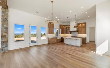 Kitchen island view toward the great room in a Sterling Ranch custom home with bright finishes and open layout