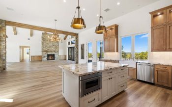 Open-concept Sterling Ranch custom home with kitchen flowing into great room and tall ceilings