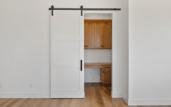 Built-in desk nook with cabinetry in a Sterling Ranch custom home