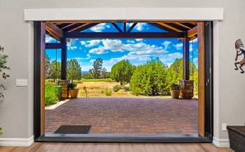 Interior great room opening to covered patio with golf course views in Talking Rock Ranch