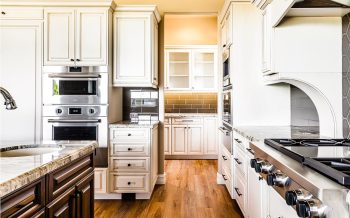 Butler pantry connecting to Kokopelli custom home kitchen in Talking Rock Ranch with white cabinets and subway tile backsplash