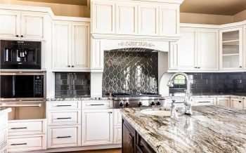 Closeup of custom range and decorative tile backsplash in Kokopelli custom home kitchen in Talking Rock Ranch Prescott AZ